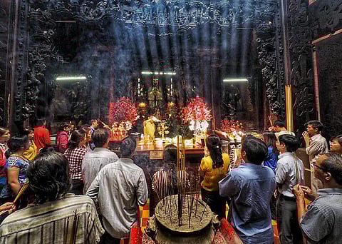 People offering prayers at the Jade Emperor Pagoda